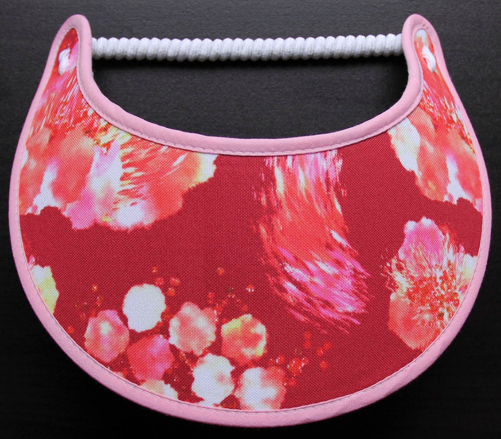 Foam sun visor with various shades of pink, orange and deep red